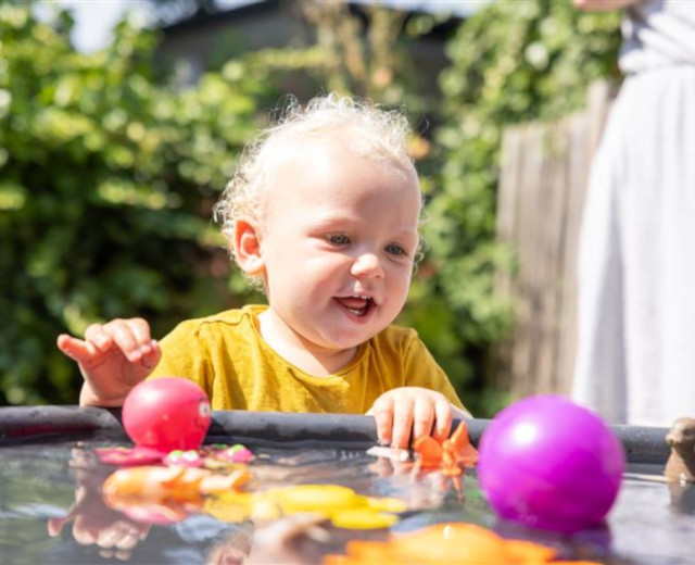 Child playing with water at a Waltham Forest Family Hub