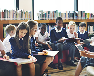 Children in a classroom with handbooks