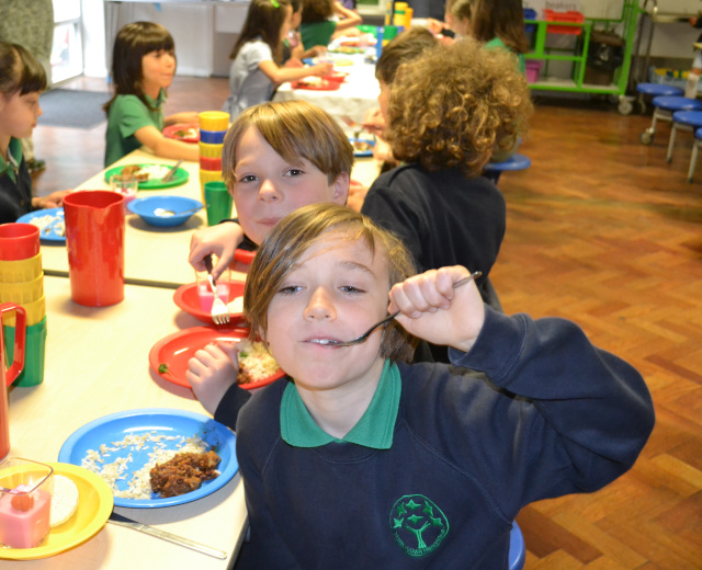 young boy eating school dinners
